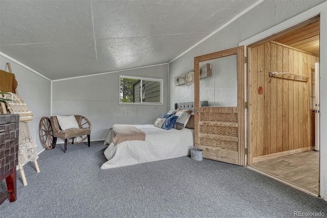 bedroom with carpet floors, a textured ceiling, and vaulted ceiling