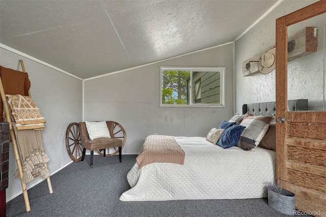 carpeted bedroom featuring a textured wall, a textured ceiling, and lofted ceiling