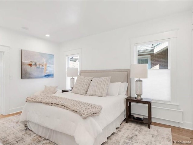 bedroom featuring recessed lighting, light wood-style floors, and baseboards