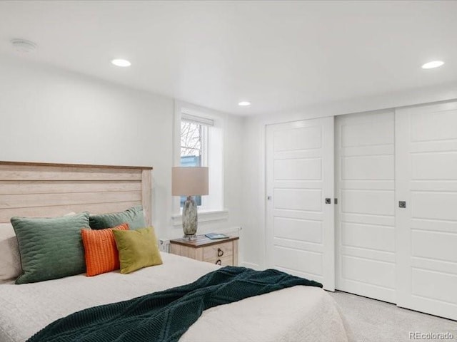 carpeted bedroom with recessed lighting and a closet