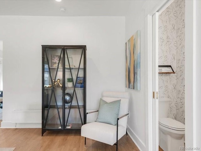 sitting room with wood finished floors and baseboards