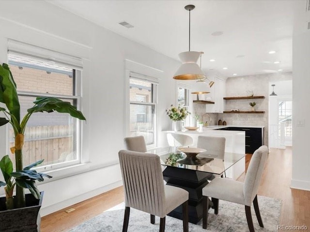 dining room featuring visible vents, recessed lighting, light wood-type flooring, and baseboards