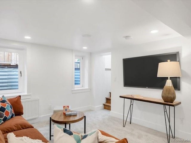 living area with recessed lighting, stairs, radiator heating unit, and baseboards