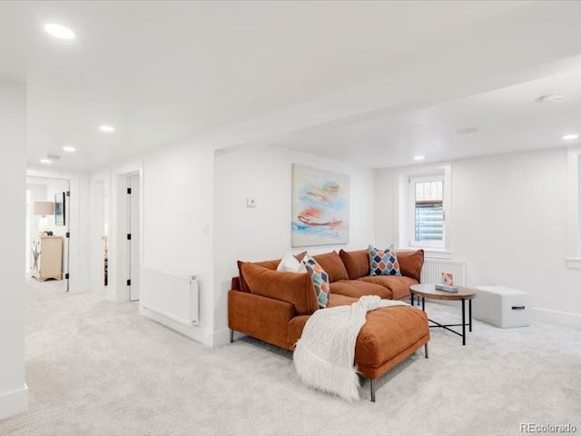 living room with radiator heating unit, light colored carpet, recessed lighting, and baseboards