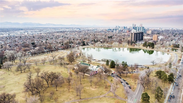 aerial view at dusk with a water view and a view of city