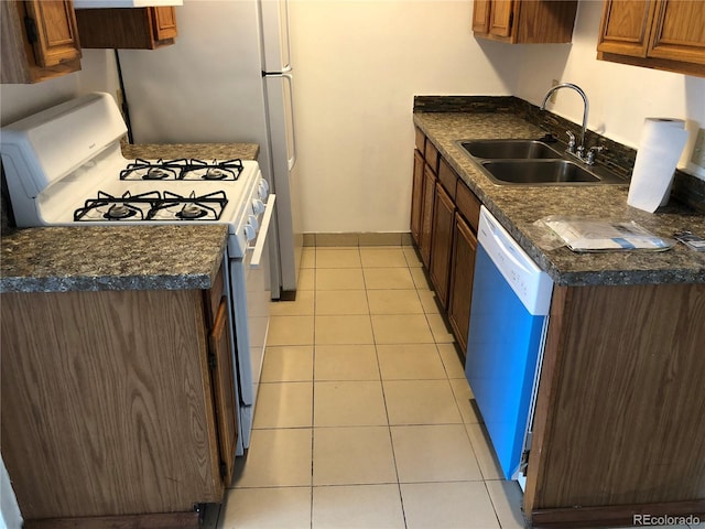 kitchen with sink, dishwasher, light tile floors, and gas range gas stove