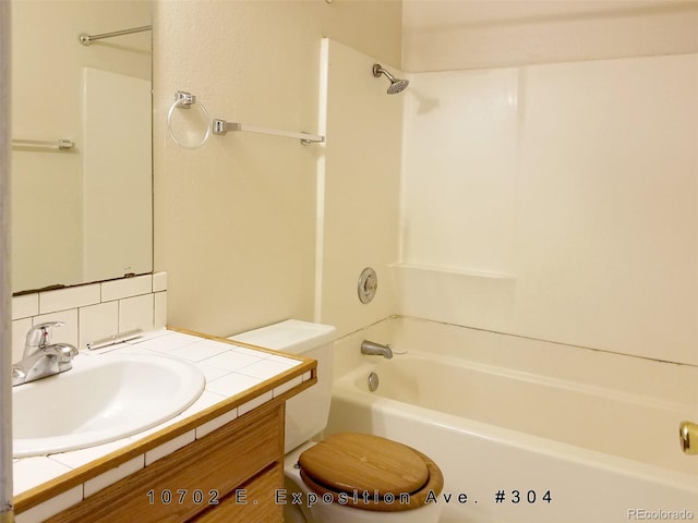 full bathroom featuring backsplash, toilet, bathing tub / shower combination, and large vanity