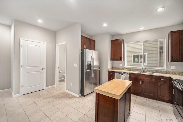 11250 Florence St Unit 29D, Commerce City, CO 80640 - kitchen featuring appliances with stainless steel finishes, a sink, butcher block counters, recessed lighting, and light tile patterned flooring