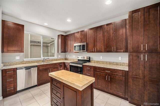 11250 Florence St Unit 29D, Commerce City, CO 80640 - kitchen featuring stainless steel appliances, butcher block counters, a sink, light tile patterned flooring, and recessed lighting