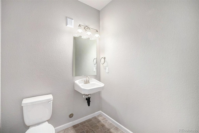 11250 Florence St Unit 29D, Commerce City, CO 80640 - half bathroom with toilet, a sink, and baseboards