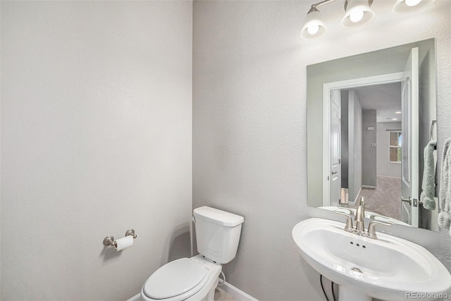11250 Florence St Unit 29D, Commerce City, CO 80640 - bathroom with a sink, toilet, and baseboards