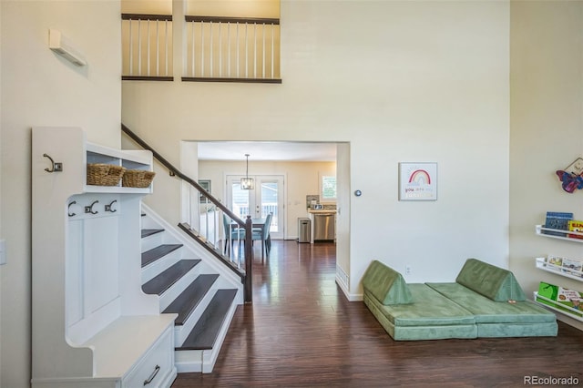 2695 Woodrose Pl, Highlands Ranch, CO 80129 - stairs with wood finished floors and a chandelier