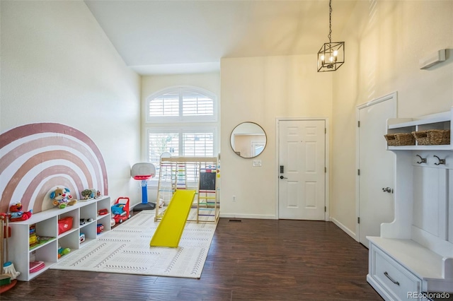 2695 Woodrose Pl, Highlands Ranch, CO 80129 - rec room with dark wood-style floors, a high ceiling, and a chandelier
