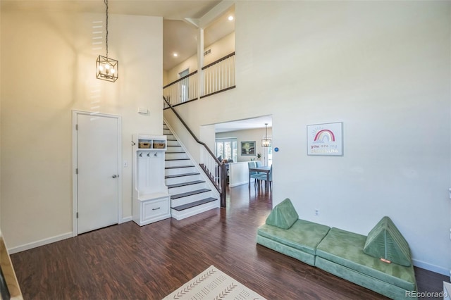 2695 Woodrose Pl, Highlands Ranch, CO 80129 - entrance foyer with a chandelier, stairs, wood finished floors, and a towering ceiling
