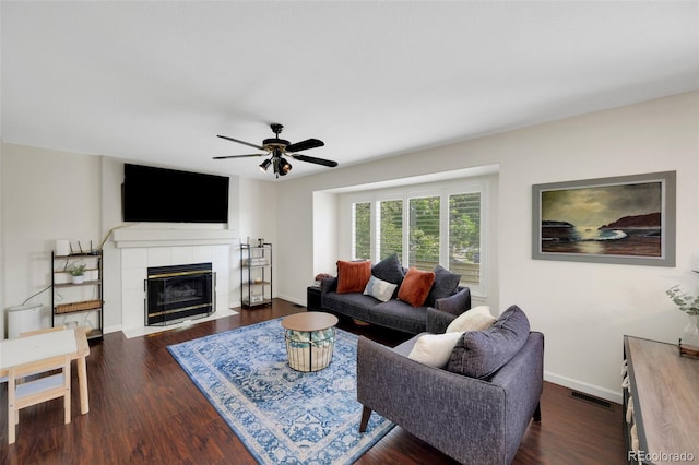 2695 Woodrose Pl, Highlands Ranch, CO 80129 - living area with a ceiling fan, dark wood-type flooring, and a tile fireplace