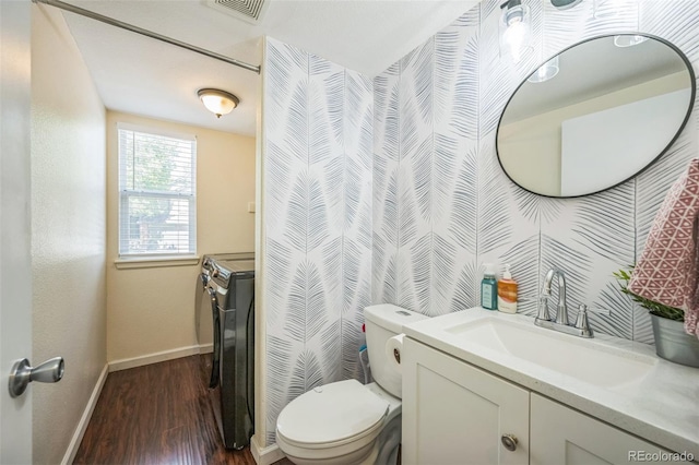 2695 Woodrose Pl, Highlands Ranch, CO 80129 - bathroom with wood finished floors, vanity, and independent washer and dryer