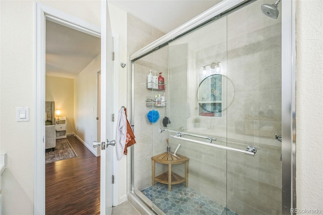 2695 Woodrose Pl, Highlands Ranch, CO 80129 - full bathroom featuring a stall shower and wood finished floors