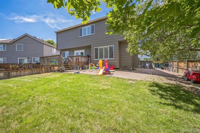 2695 Woodrose Pl, Highlands Ranch, CO 80129 - rear view of house featuring a wooden deck, a fenced backyard, and a patio