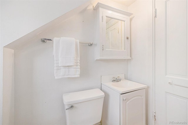 bathroom featuring toilet and vanity