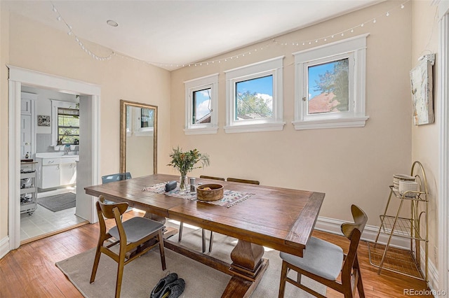 dining room with baseboards and light wood-style floors