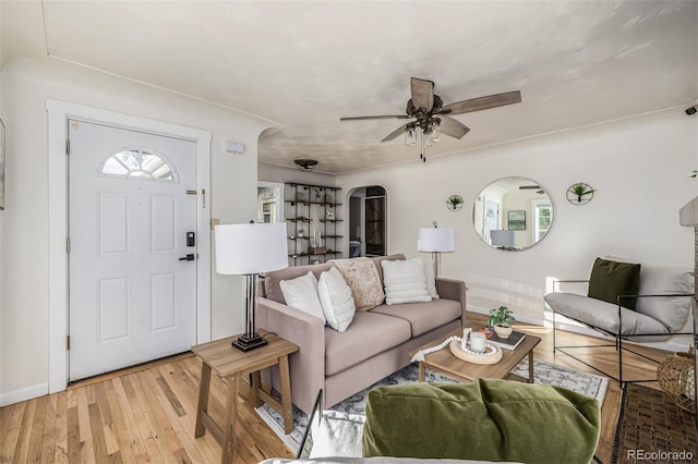 living room with ceiling fan and light hardwood / wood-style floors