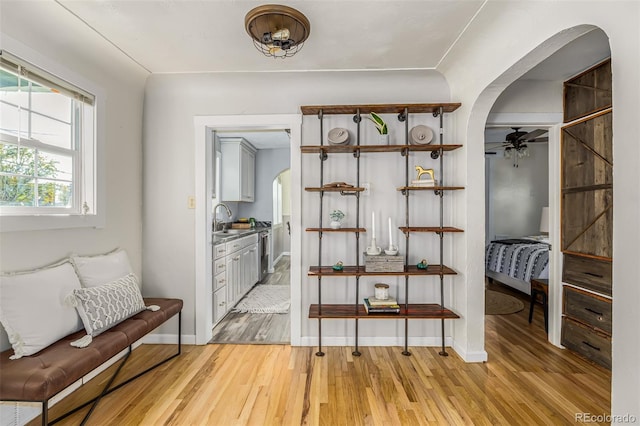 interior space with ceiling fan, light wood-type flooring, and sink