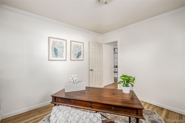 office area with ornamental molding and light hardwood / wood-style floors