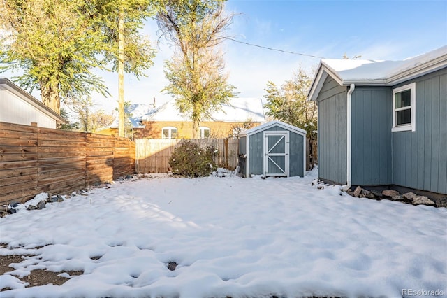 snowy yard with a shed