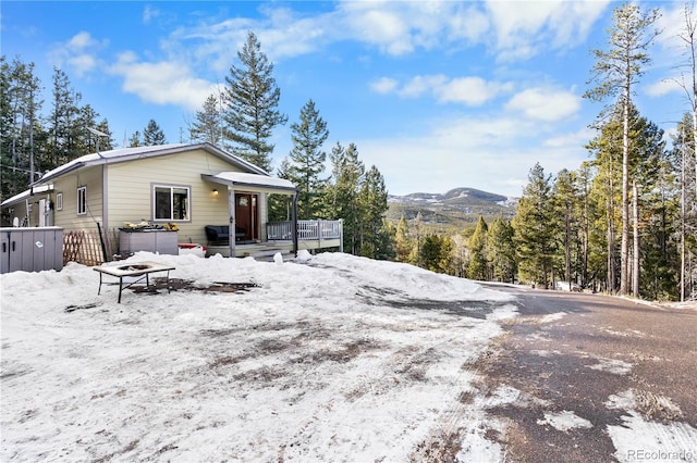 view of front of house featuring a fire pit and a mountain view