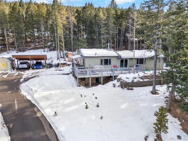 exterior space featuring a deck and a carport