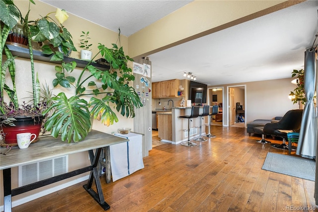 entryway with light hardwood / wood-style flooring and sink