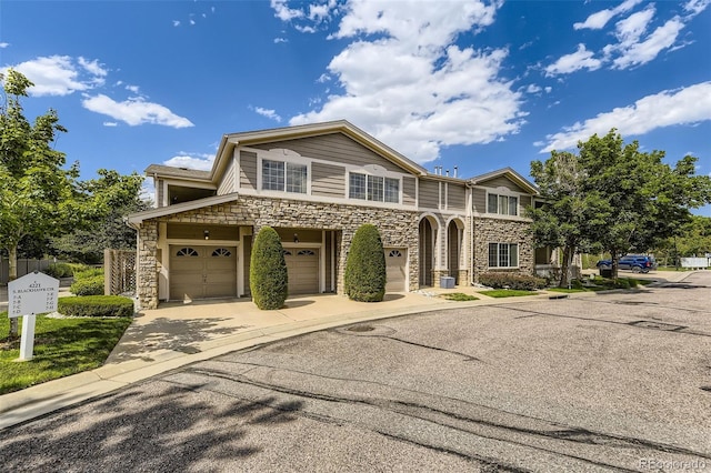 4221 S Blackhawk Cir Unit 7G, Aurora, CO 80014 - view of front of home with stone siding, a garage, and driveway