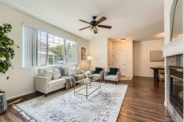 4221 S Blackhawk Cir Unit 7G, Aurora, CO 80014 - living area with a ceiling fan, a tiled fireplace, and dark wood-style flooring