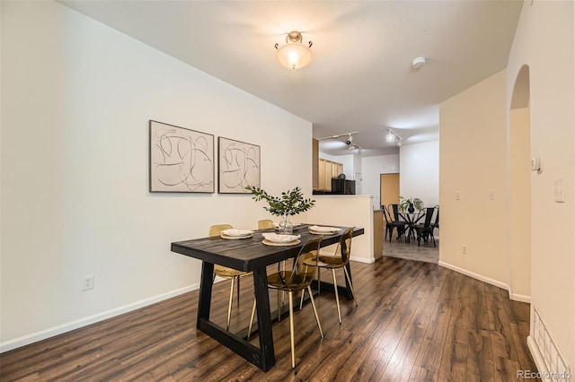 4221 S Blackhawk Cir Unit 7G, Aurora, CO 80014 - dining area featuring dark wood-type flooring and arched walkways