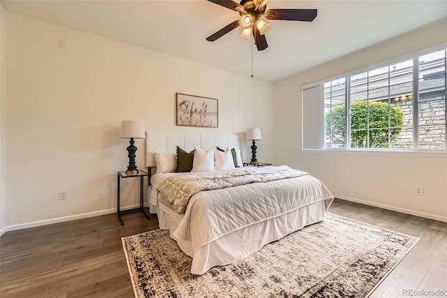 4221 S Blackhawk Cir Unit 7G, Aurora, CO 80014 - bedroom with multiple windows, wood finished floors, and a ceiling fan