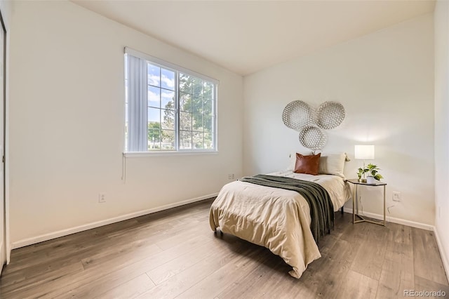 4221 S Blackhawk Cir Unit 7G, Aurora, CO 80014 - bedroom with wood finished floors and baseboards
