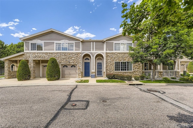 4221 S Blackhawk Cir Unit 7G, Aurora, CO 80014 - townhome / multi-family property with stone siding, an attached garage, and concrete driveway