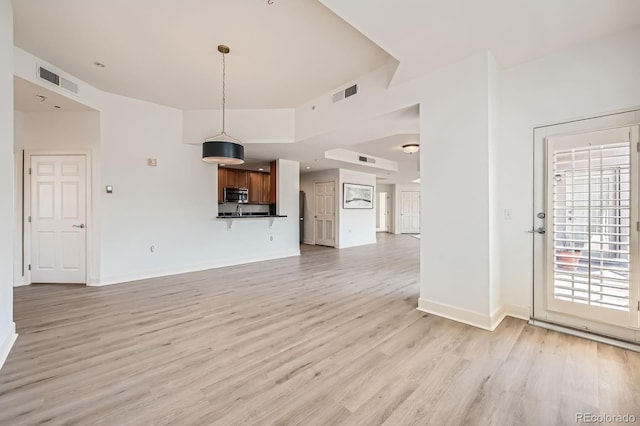 475 W 12th Ave Unit 9A, Denver, CO 80204 - unfurnished living room with light wood finished floors and baseboards
