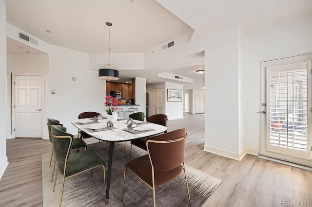 475 W 12th Ave Unit 9A, Denver, CO 80204 - dining room with light wood-style flooring and baseboards