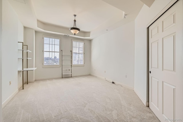 475 W 12th Ave Unit 9A, Denver, CO 80204 - spare room with carpet floors, a tray ceiling, and baseboards