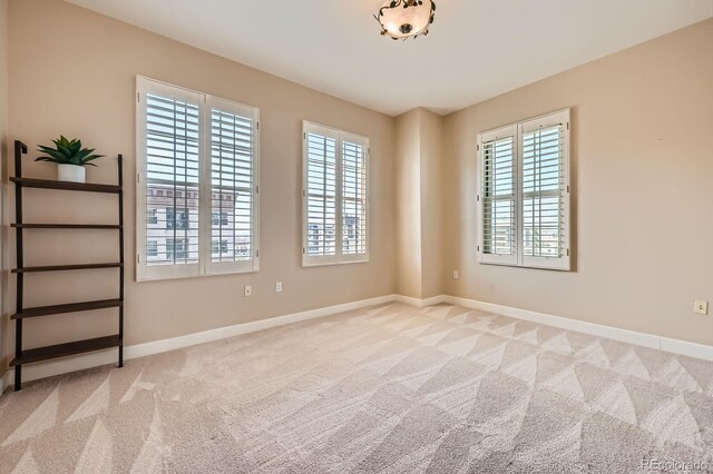 475 W 12th Ave Unit 9A, Denver, CO 80204 - unfurnished room featuring healthy amount of natural light, carpet floors, and baseboards