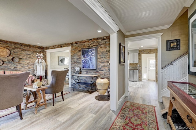 interior space with light hardwood / wood-style floors and crown molding