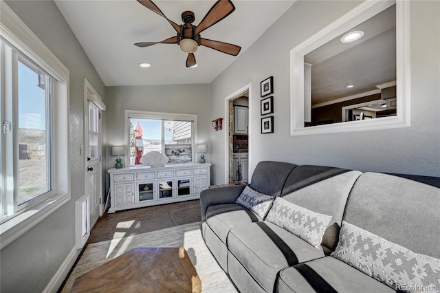 living room with ceiling fan, lofted ceiling, and a wealth of natural light