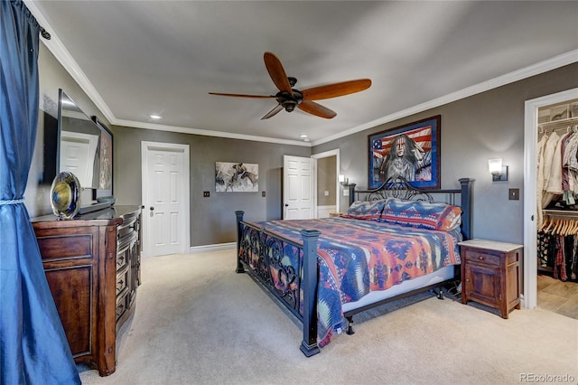 carpeted bedroom with a closet, ceiling fan, and ornamental molding