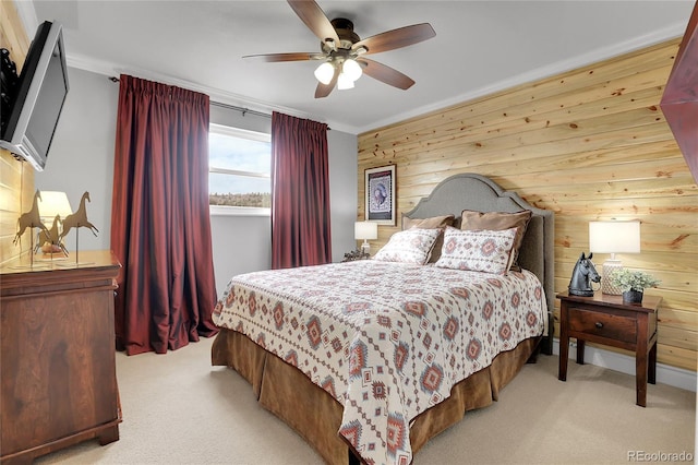 carpeted bedroom with ceiling fan, crown molding, and wooden walls