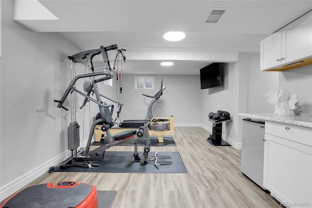 exercise area featuring light hardwood / wood-style floors