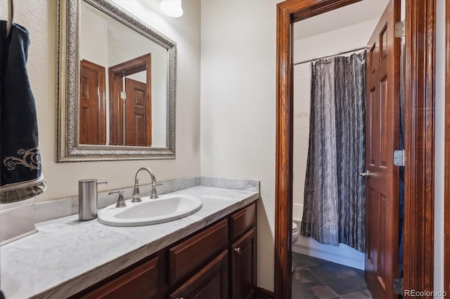 full bathroom with toilet, shower / bath combination with curtain, and vanity