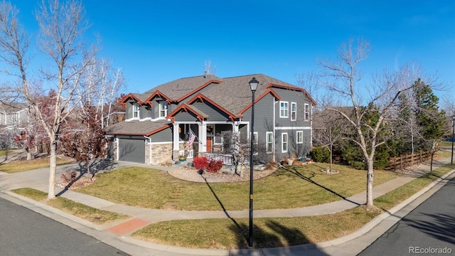 view of front of house featuring driveway, a garage, and a front yard