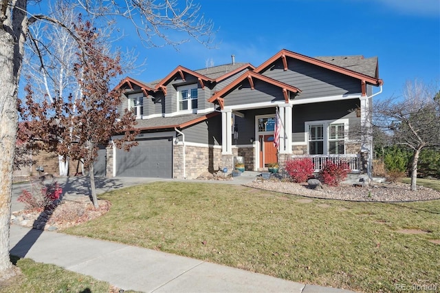 craftsman-style home with stone siding, a porch, concrete driveway, and a front yard