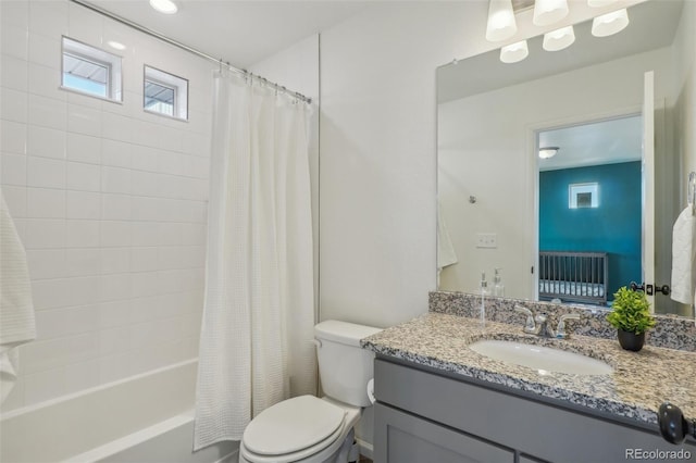 full bathroom with vanity, shower / bath combo with shower curtain, and toilet